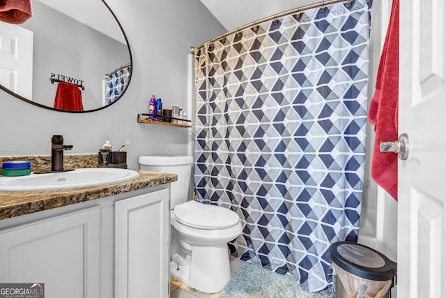 bathroom with tile patterned floors, vanity, a shower with shower curtain, and toilet