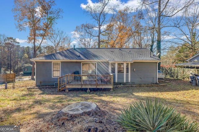 view of front of house with a deck and a front yard