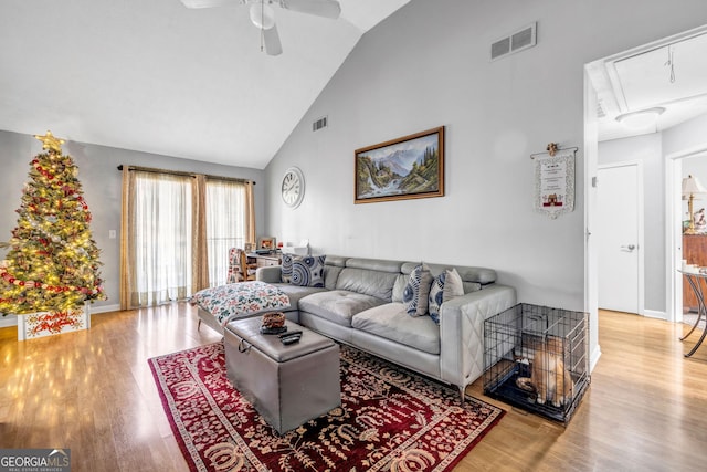 living room featuring ceiling fan, wood-type flooring, and high vaulted ceiling