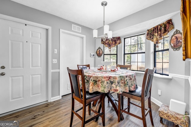 dining room featuring a notable chandelier and wood-type flooring