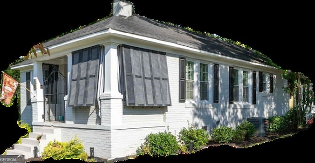 view of home's exterior featuring central air condition unit and a sunroom