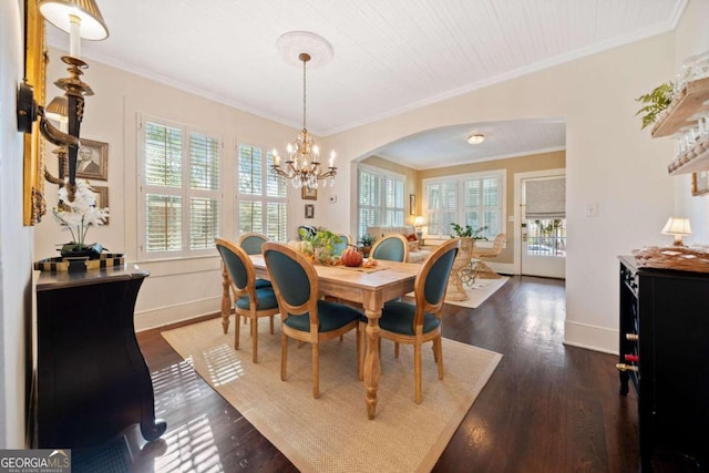 dining area featuring dark wood-type flooring, ornamental molding, and a wealth of natural light