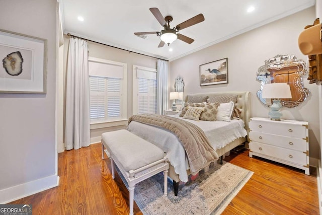 bedroom featuring ornamental molding, hardwood / wood-style floors, and ceiling fan