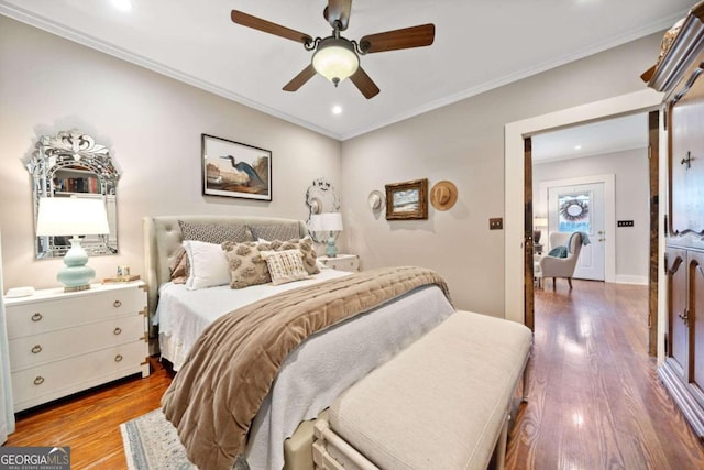 bedroom with ceiling fan, hardwood / wood-style flooring, and ornamental molding