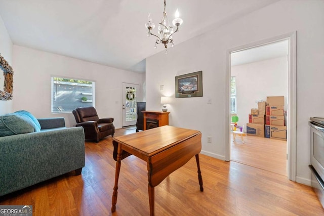 living room with a chandelier and light hardwood / wood-style flooring