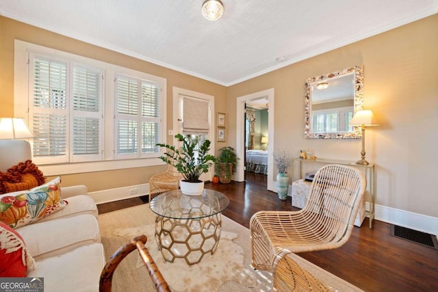 living area with ornamental molding and dark wood-type flooring