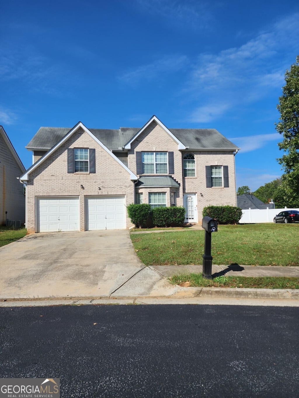 view of front of property with a garage and a front lawn