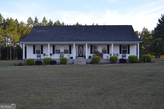 ranch-style home with covered porch and a front yard