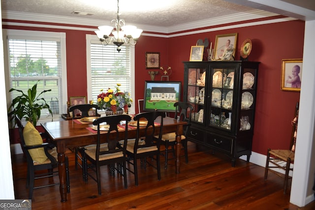 dining room with dark hardwood / wood-style floors, ornamental molding, and a textured ceiling