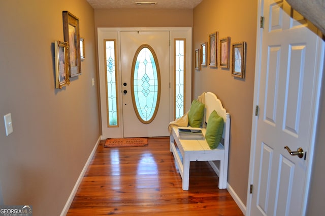 entrance foyer featuring wood-type flooring and a textured ceiling