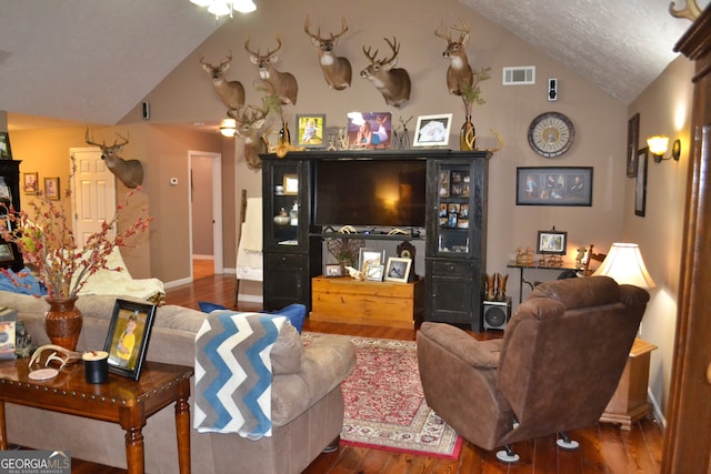 living room with vaulted ceiling and wood-type flooring