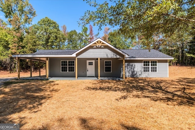 ranch-style home with a patio and a carport