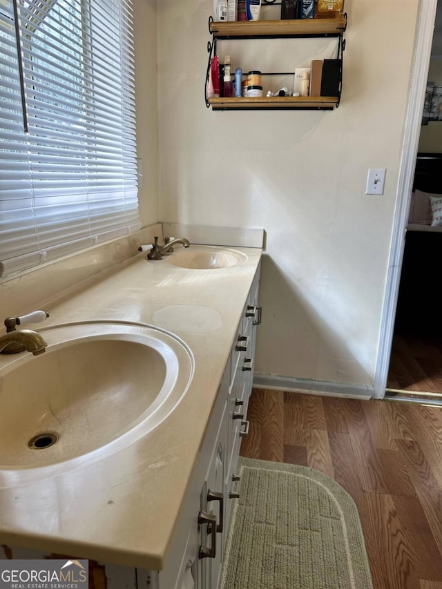 bathroom with hardwood / wood-style flooring and vanity