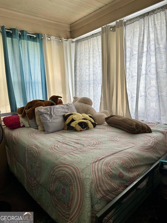 bedroom featuring crown molding and wooden ceiling