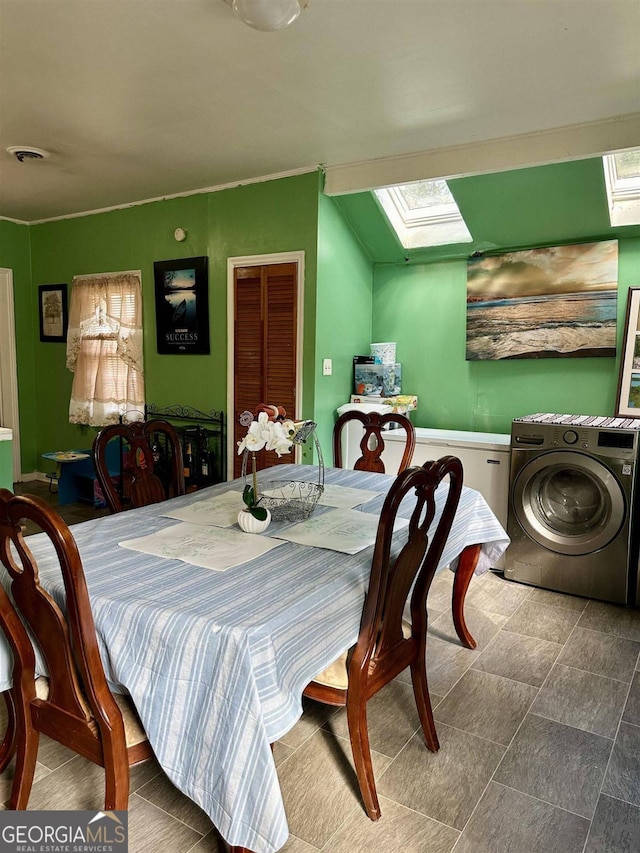 dining space featuring washer / clothes dryer and a skylight