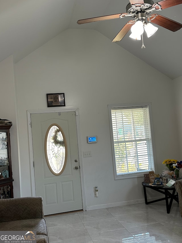 tiled foyer entrance featuring ceiling fan and vaulted ceiling