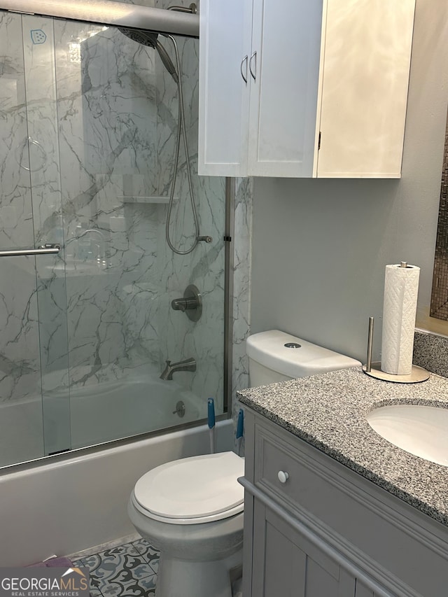 full bathroom with vanity, shower / bath combination with glass door, and toilet