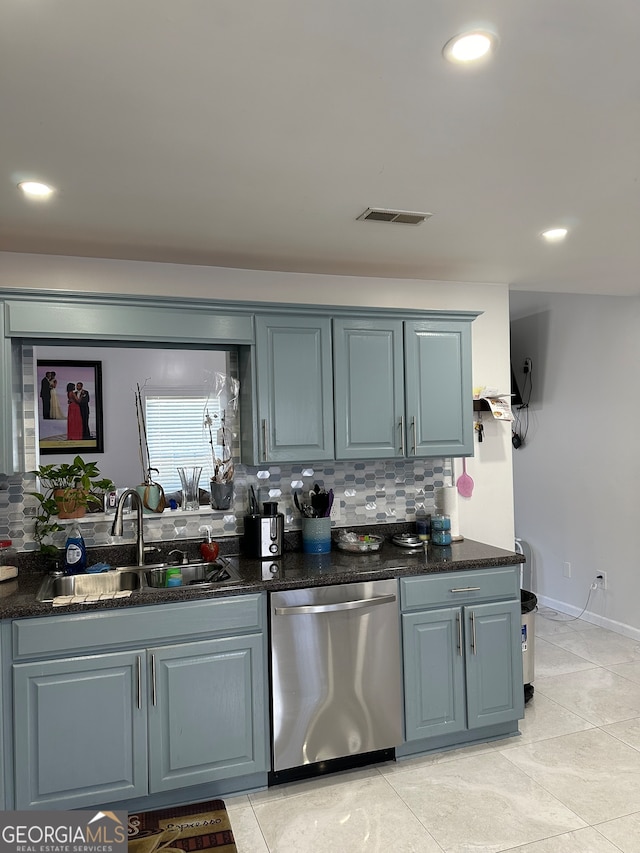 bar with tasteful backsplash, sink, light tile patterned flooring, dark stone counters, and stainless steel dishwasher