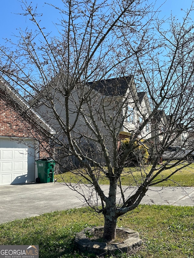 view of property exterior featuring a yard and a garage