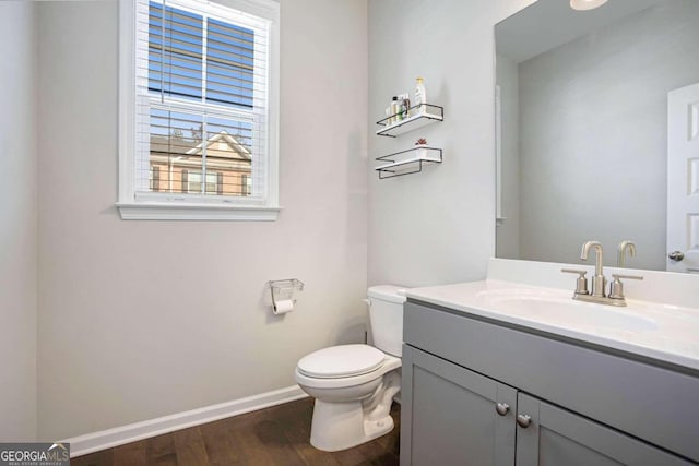 bathroom featuring hardwood / wood-style flooring, vanity, and toilet