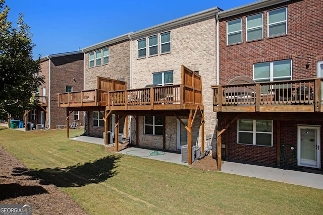 back of property featuring a patio, a lawn, and a deck