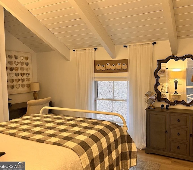 bedroom featuring vaulted ceiling with beams, wood ceiling, and light hardwood / wood-style flooring