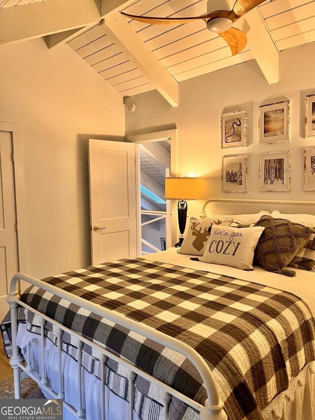 bedroom with lofted ceiling with beams and wood ceiling