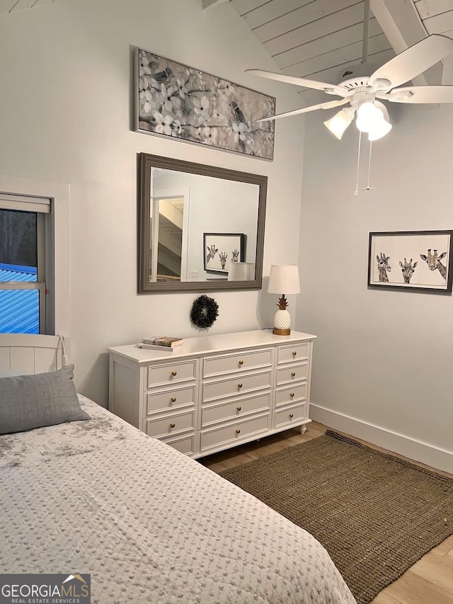 bedroom featuring ceiling fan, lofted ceiling, and light wood-type flooring