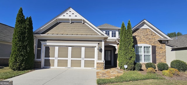 5911 Chimney Rock Dr, Hoschton, GA 30548 - view of front of house featuring driveway and stone siding