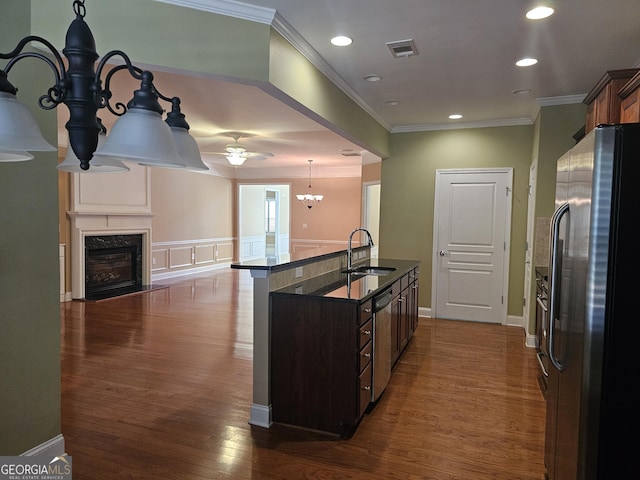 5911 Chimney Rock Dr, Hoschton, GA 30548 - kitchen with a sink, stainless steel appliances, a high end fireplace, dark wood-type flooring, and ornamental molding