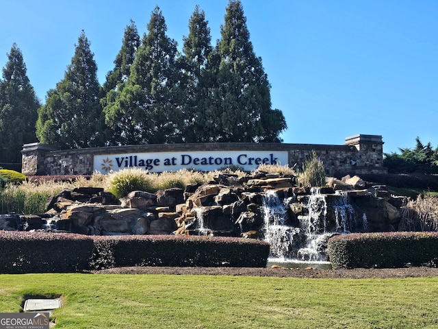 community sign featuring a lawn