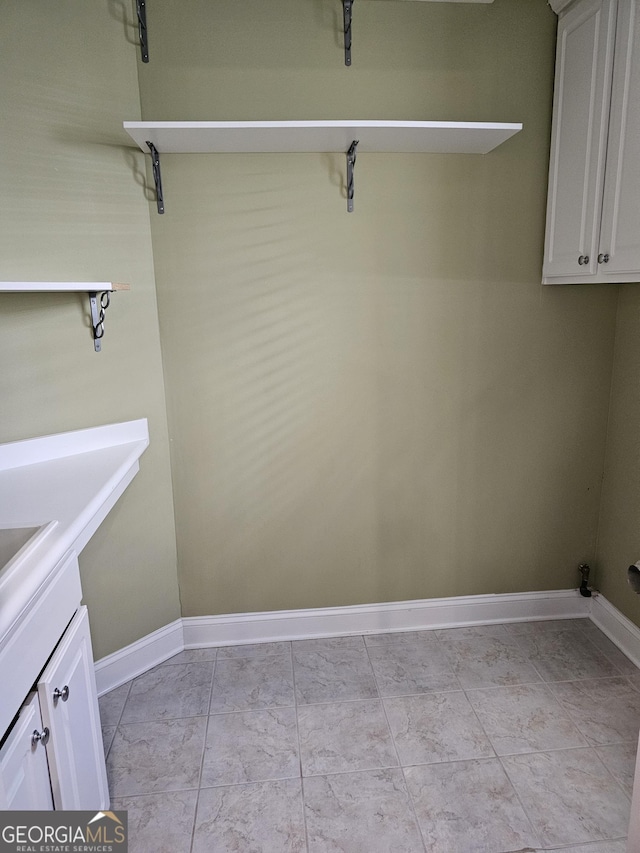 5911 Chimney Rock Dr, Hoschton, GA 30548 - washroom featuring baseboards and a sink
