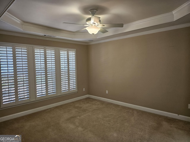 5911 Chimney Rock Dr, Hoschton, GA 30548 - spare room with carpet flooring, ceiling fan, a tray ceiling, visible vents, and ornamental molding