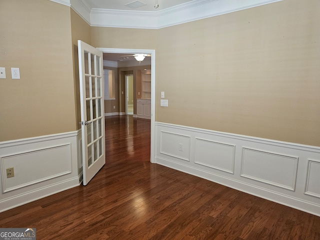 spare room featuring ornamental molding, ceiling fan, french doors, and dark hardwood / wood-style floors