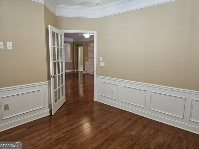 5911 Chimney Rock Dr, Hoschton, GA 30548 - empty room with a wainscoted wall, ornamental molding, a decorative wall, and dark wood-style flooring