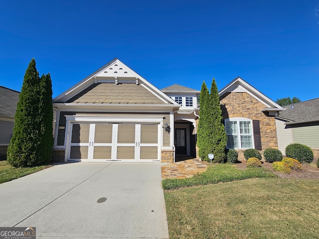 view of front of property with a front lawn and a garage