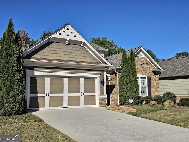 5911 Chimney Rock Dr, Hoschton, GA 30548 - craftsman house featuring concrete driveway, a shingled roof, and stone siding