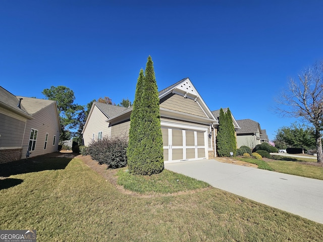 5911 Chimney Rock Dr, Hoschton, GA 30548 - view of side of property featuring a yard, concrete driveway, and a garage
