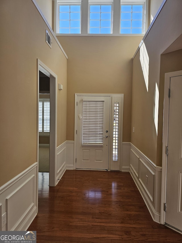 5911 Chimney Rock Dr, Hoschton, GA 30548 - entrance foyer featuring a decorative wall, wainscoting, and dark wood finished floors