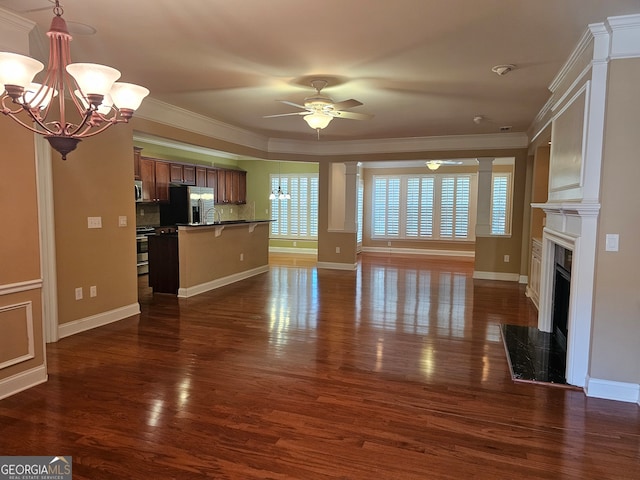 unfurnished living room with ceiling fan with notable chandelier, crown molding, a high end fireplace, and dark hardwood / wood-style flooring