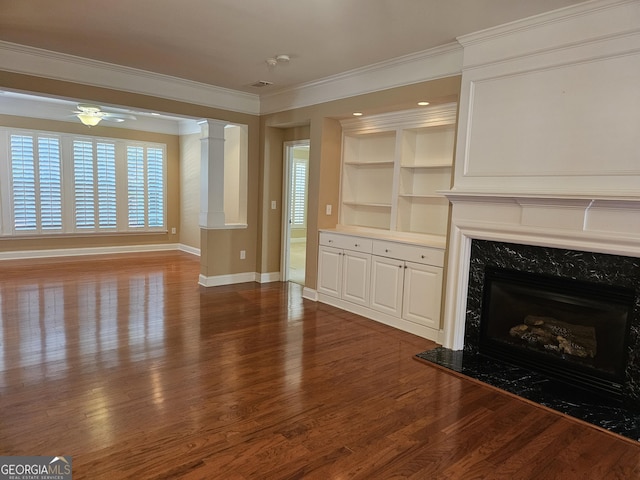 5911 Chimney Rock Dr, Hoschton, GA 30548 - unfurnished living room featuring a high end fireplace, built in features, wood finished floors, baseboards, and ornamental molding