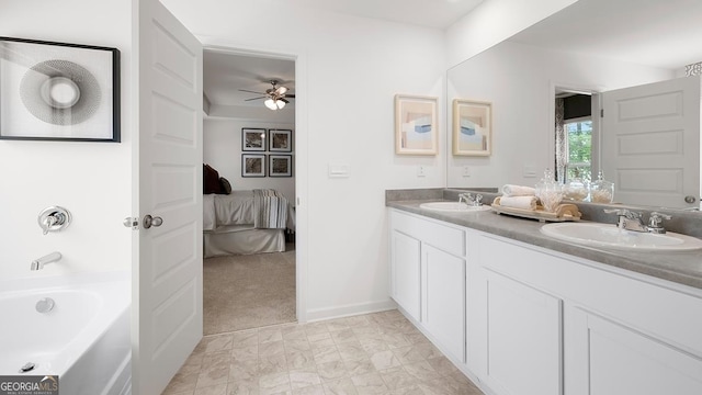 bathroom with a tub to relax in, vanity, and ceiling fan