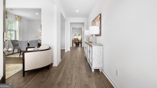 corridor with hardwood / wood-style flooring