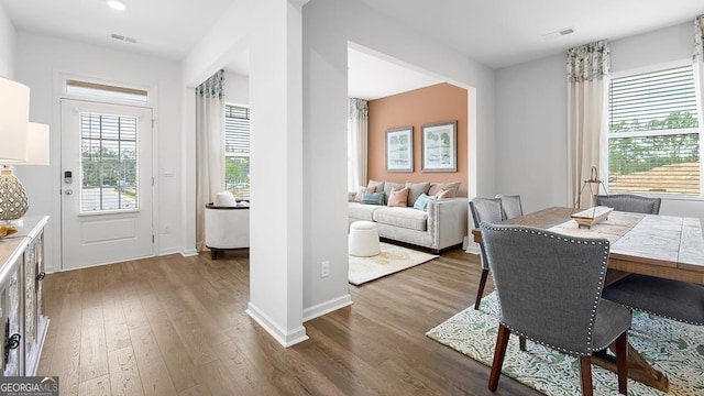 dining space with hardwood / wood-style flooring