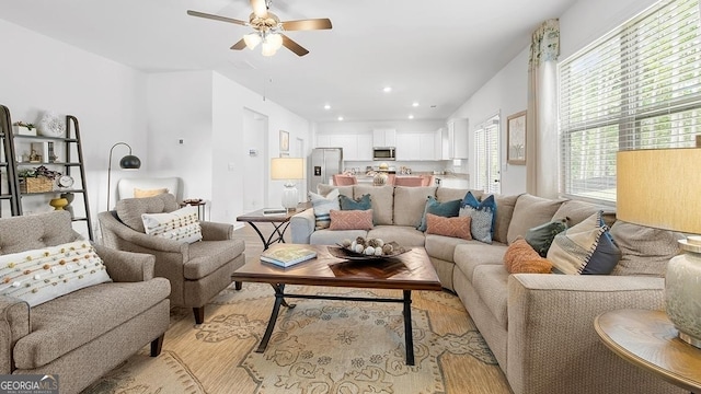 living room featuring ceiling fan and light hardwood / wood-style floors