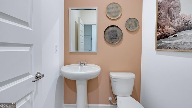 bathroom featuring sink and toilet