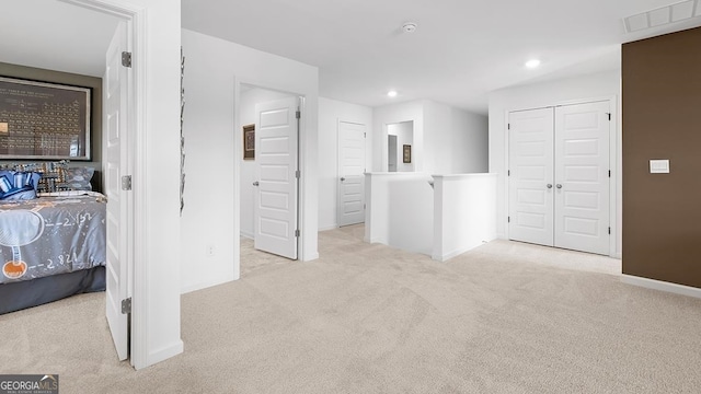 bedroom featuring light carpet and a closet