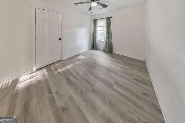 83 Sunset Ln, Newnan, GA 30263 - spare room featuring wood finished floors, baseboards, and a ceiling fan