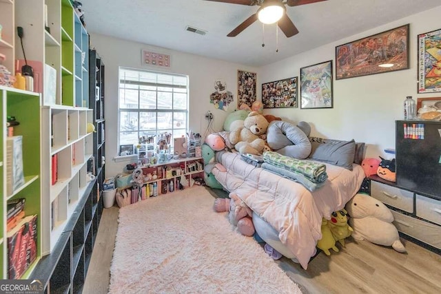 83 Sunset Ln, Newnan, GA 30263 - bedroom featuring wood finished floors, ceiling fan, and visible vents