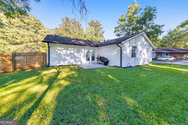 83 Sunset Ln, Newnan, GA 30263 - back of house with french doors, brick siding, fence, and a lawn